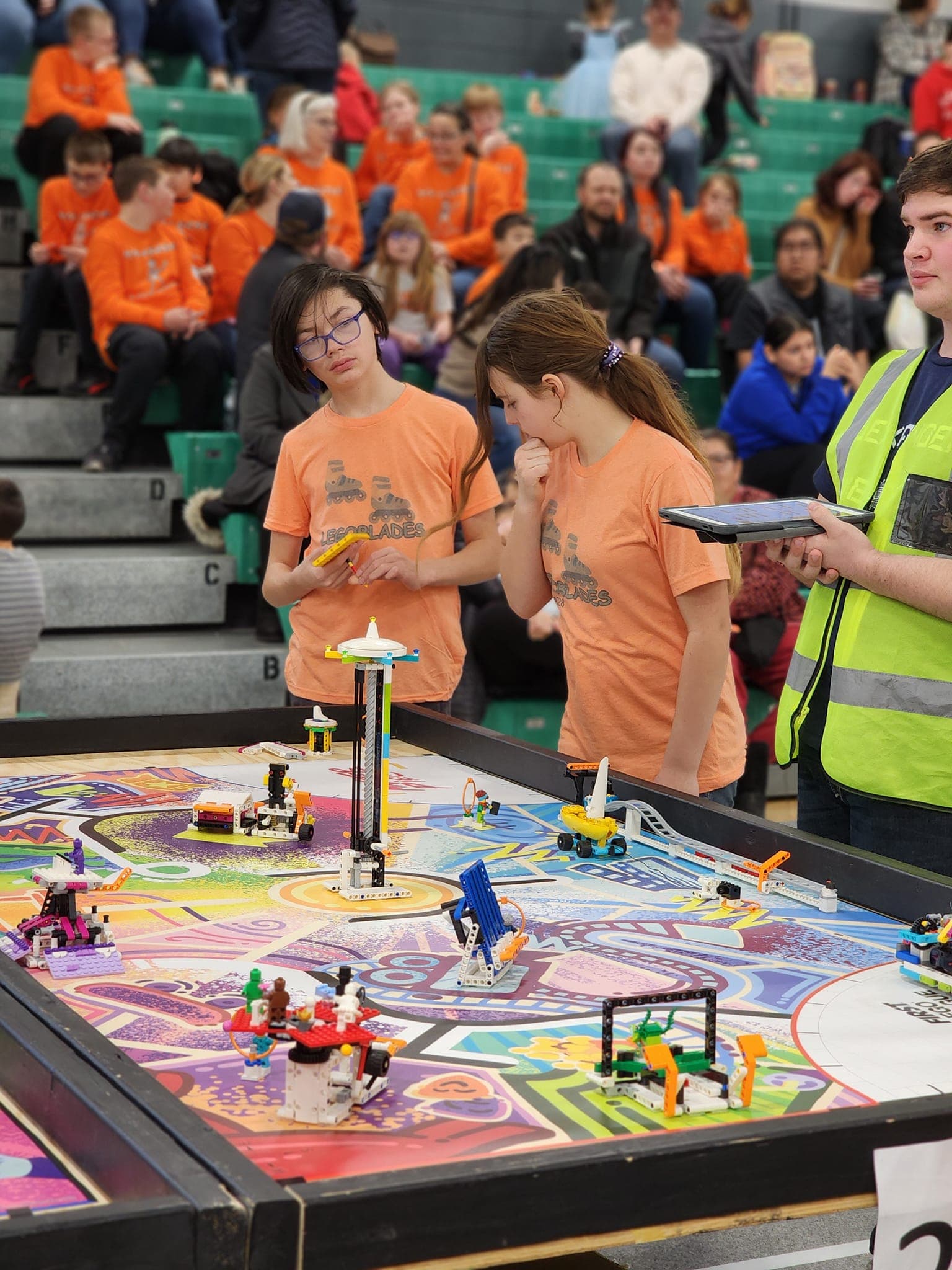 Williston Robotics FIRST LEGO League team at competition — robots on the playing field.